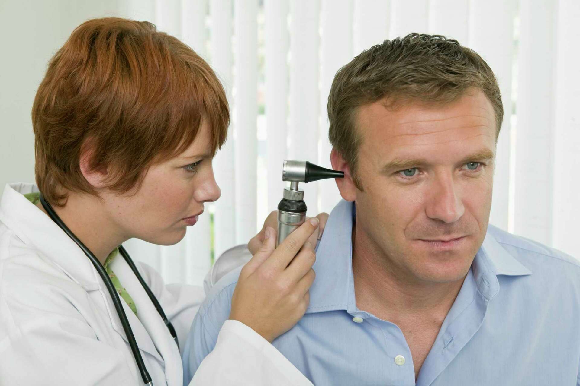 woman doctor holding otoscope ear consultation old man medical appointment otologist using otology instrument examination give medical advice ill patient